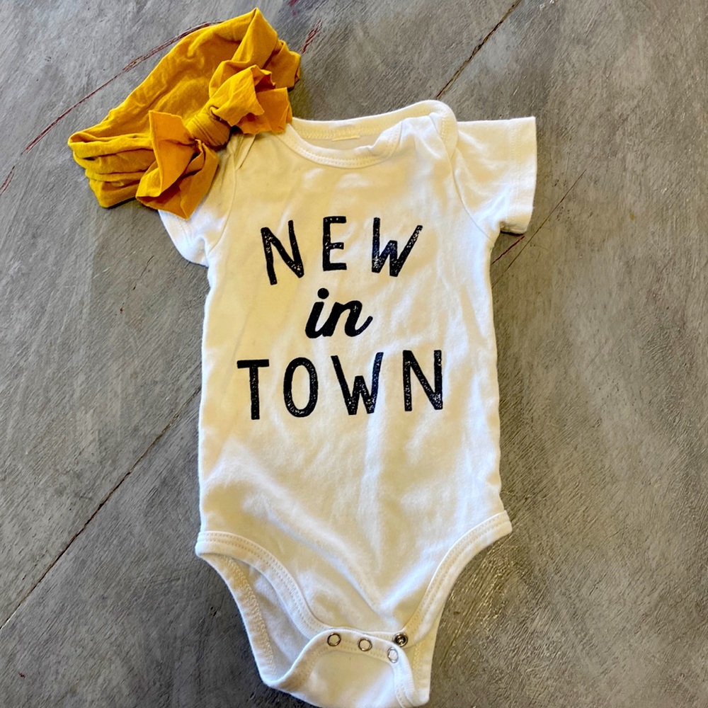 Gently used newborn onesies and bow.